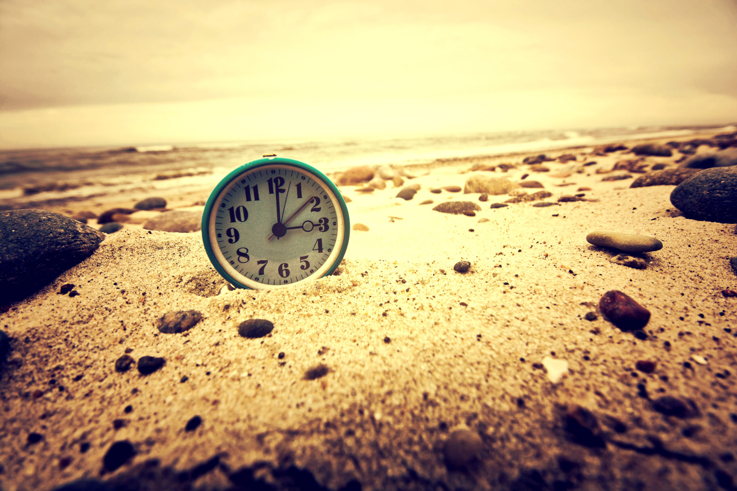 Clock on the beach. Time and business concept