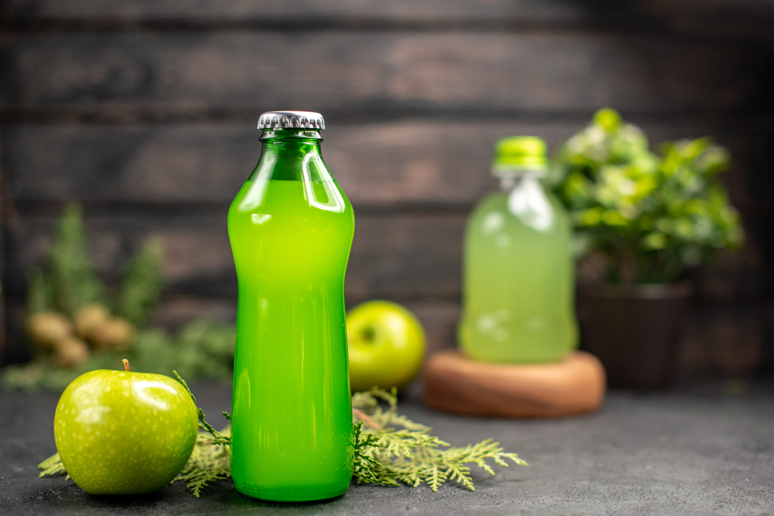 front-view-fresh-apple-lemonade-bottle-apple-potted-plant-juice-bottle