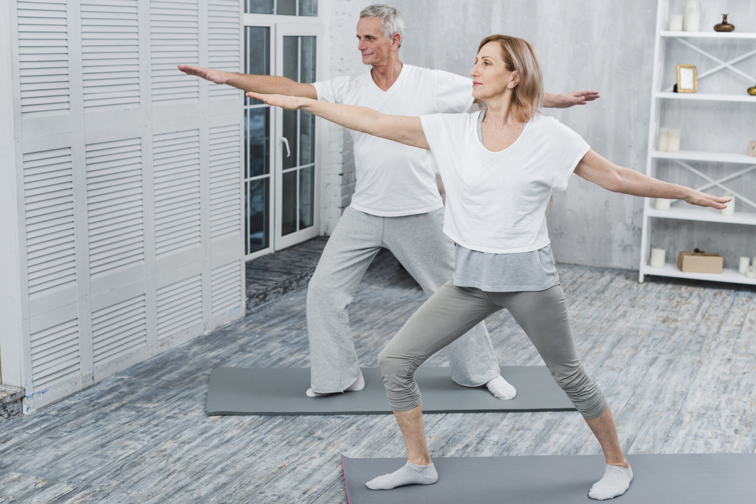 healthy-couple-performing-exercising-yoga-mat-home