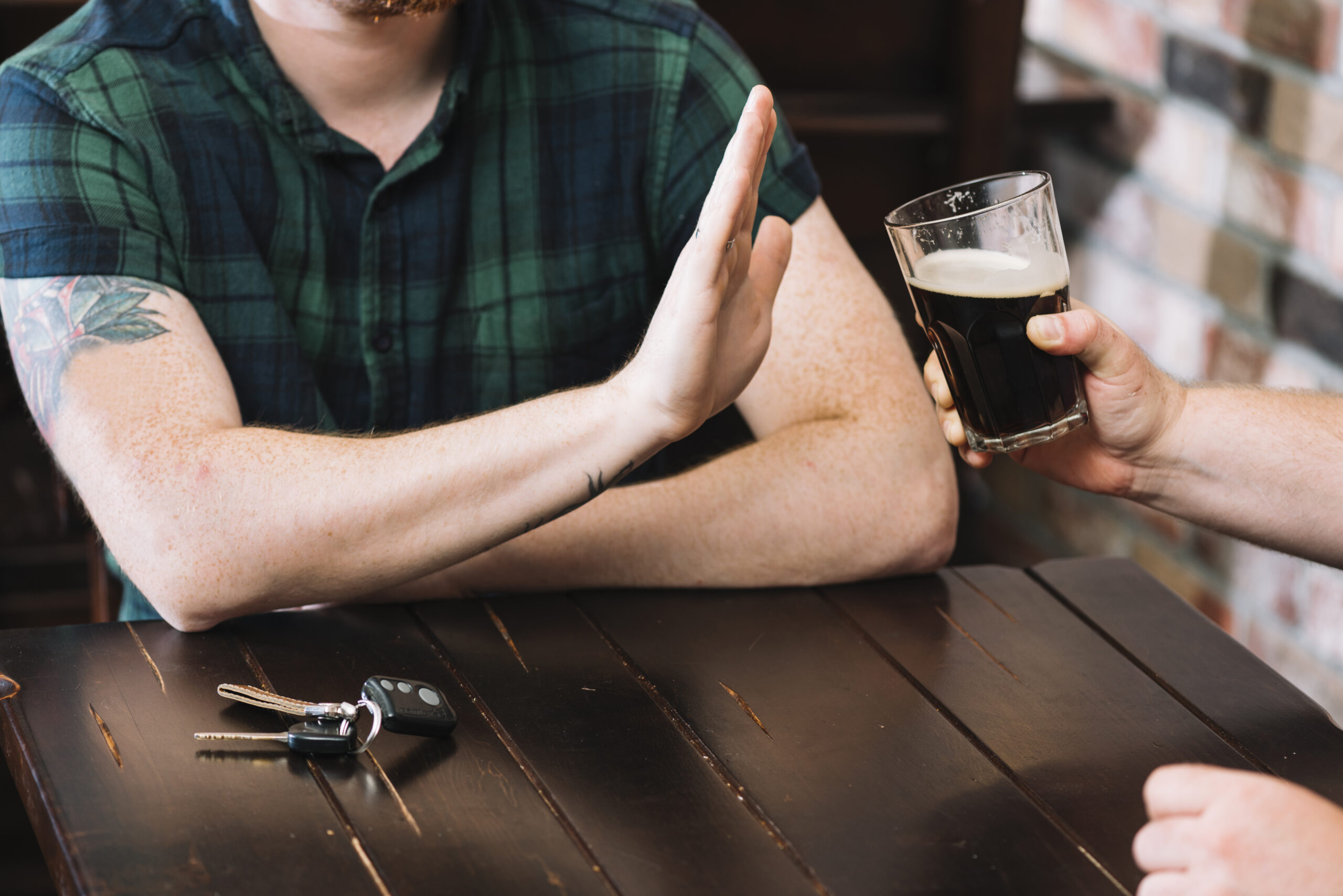 man-refusing-glass-rum-offered-by-his-friend