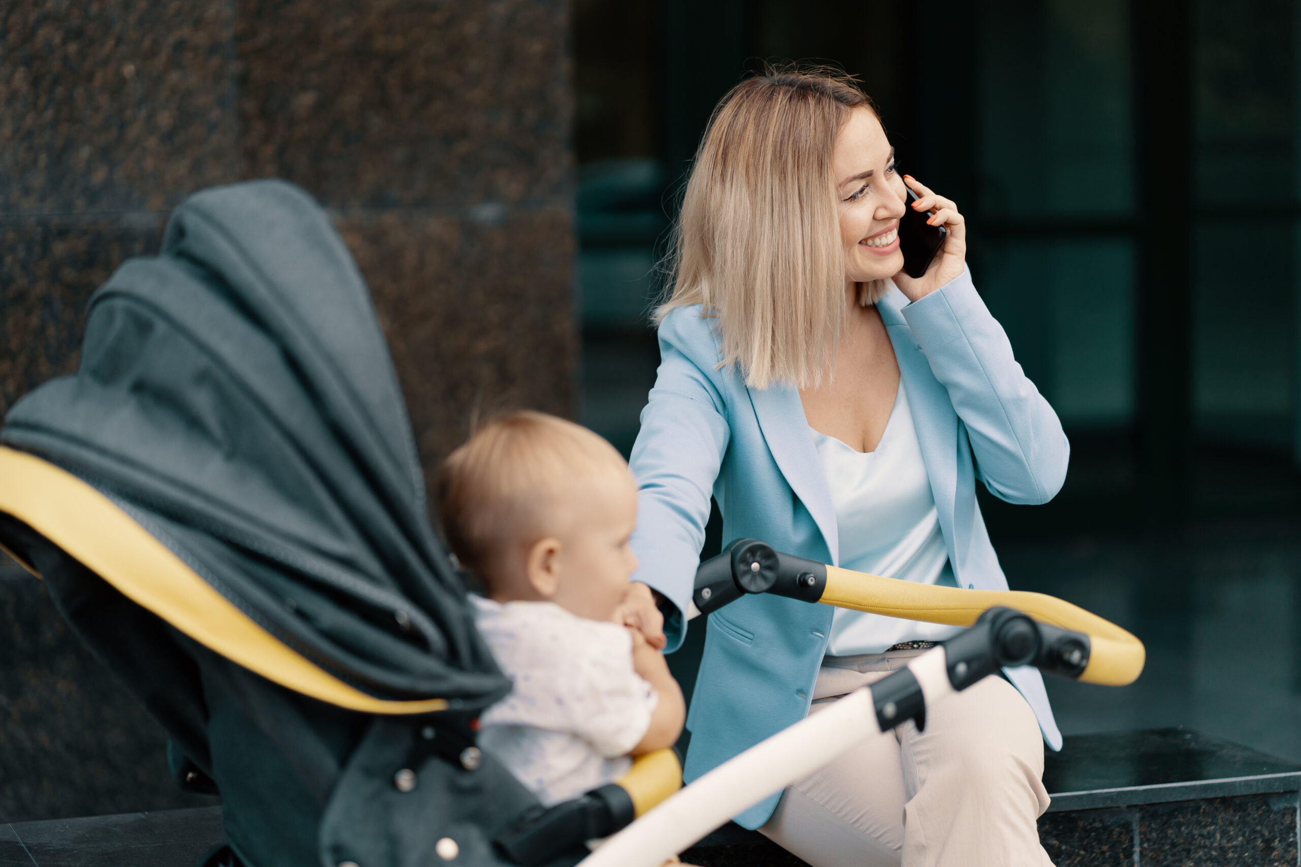 Portrait of a successful business woman in blue suit with baby