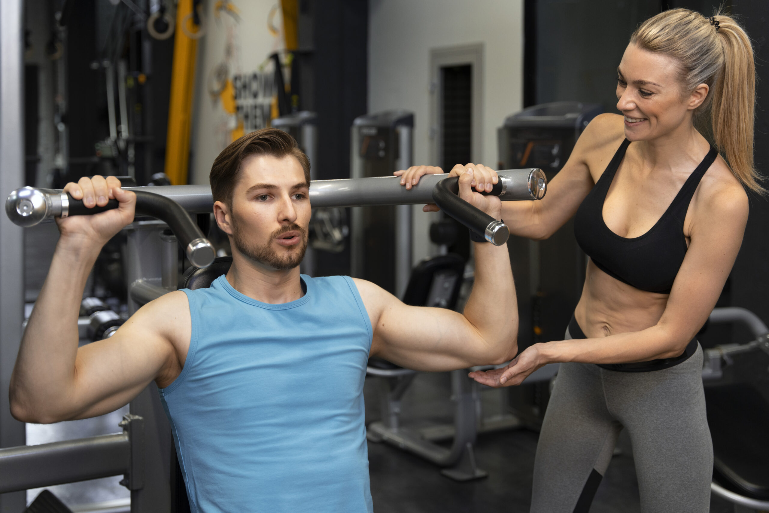 trainer-helping-beginner-gym